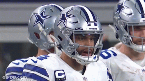 A Group Of Cowboys Players Standing In A Huddle GIF