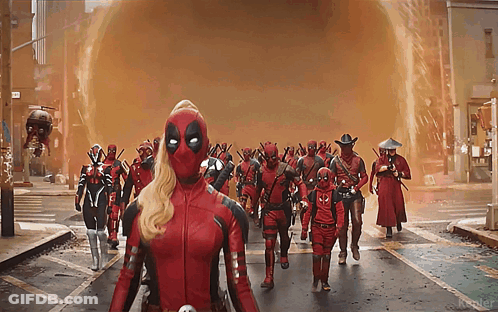 A Group Of Deadpools Walking Down A Street GIF