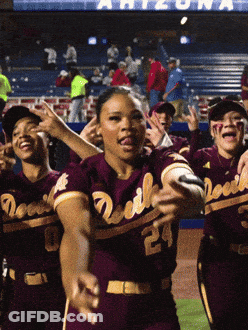 A Group Of Devils Baseball Players Are Dancing In Front Of A Crowd GIF