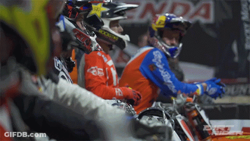 A Group Of Dirt Bike Riders Are Sitting In A Row With One Wearing A Helmet That Says Rockstar On It GIF