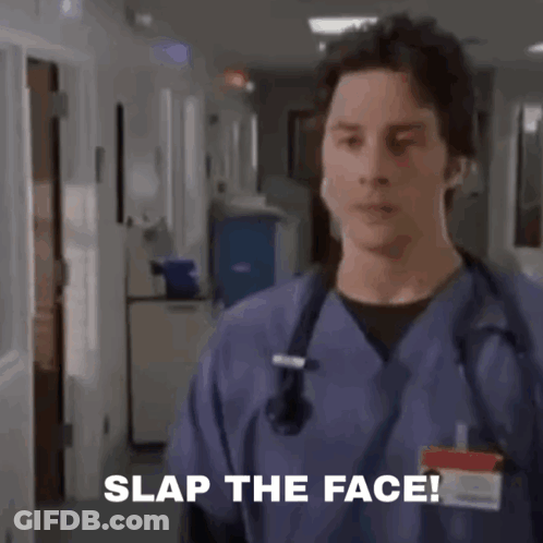 A Group Of Doctors And Nurses Are Standing In A Hospital Room And A Man Is Saying Slap The Face . GIF