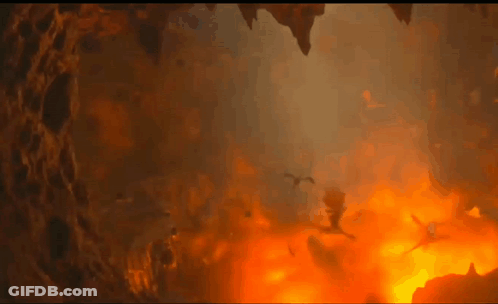 A Group Of Dragons Are Flying Through A Cave Filled With Flames And Smoke . GIF