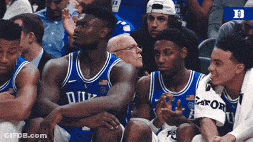 A Group Of Duke Basketball Players Are Sitting In The Stands GIF