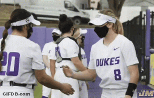 A Group Of Dukes Softball Players Wearing Face Masks GIF