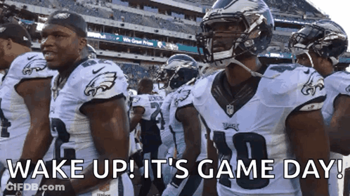 A Group Of Eagles Football Players Are Standing In A Stadium With The Words Wake Up It 'S Game Day GIF
