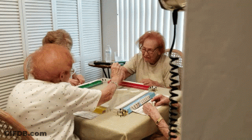 A Group Of Elderly People Are Playing Mahjong GIF