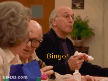 A Group Of Elderly People Are Sitting At A Table And Playing Bingo . GIF