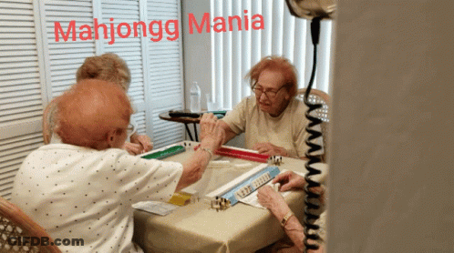 A Group Of Elderly Women Playing Mahjongg With The Words Mahjongg Mania Above Them GIF