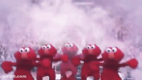 A Group Of Elmo Stuffed Animals Are Standing Next To Each Other . GIF