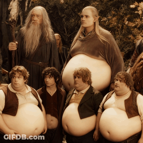A Group Of Fat Men Standing Next To Each Other With A Wizard In The Background GIF