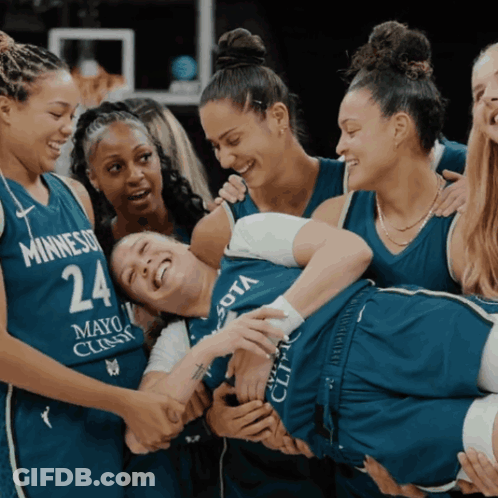 A Group Of Female Basketball Players Are Huddled Together And One Has The Number 24 On Her Jersey GIF