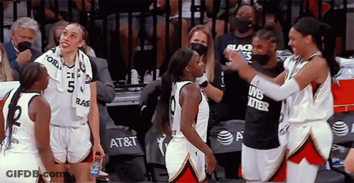 A Group Of Female Basketball Players Are Standing On The Court And One Of Them Is Wearing A Black Shirt That Says Lives GIF