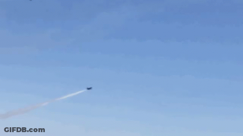 A Group Of Fighter Jets Are Flying In Formation In A Blue Sky GIF