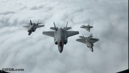 A Group Of Fighter Jets Flying In The Sky GIF