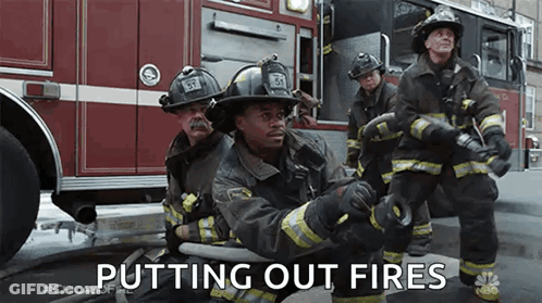 A Group Of Firefighters Are Putting Out A Fire . GIF