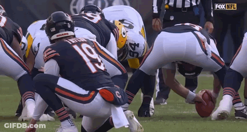 A Group Of Football Players Are Huddled Together And One Of Them Has The Number 22 On Their Jersey GIF