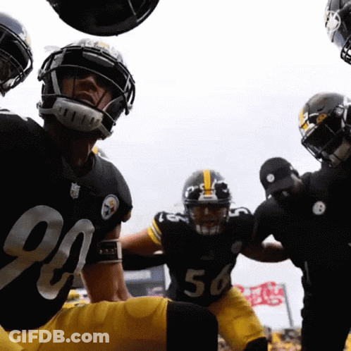 A Group Of Football Players Are Huddled Together And One Of Them Has The Number 56 On His Jersey GIF