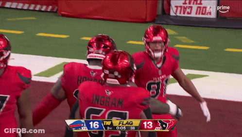 A Group Of Football Players Are Hugging Each Other On The Field And One Of Them Has The Name Ingram On His Back GIF