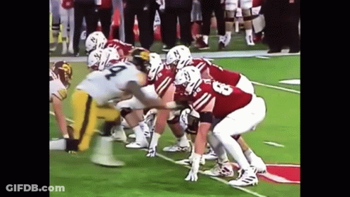 A Group Of Football Players Are Lined Up On The Field And One Of Them Has The Number 23 On Their Jersey GIF
