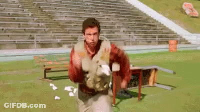 A Group Of Football Players Are Lined Up On The Field . GIF