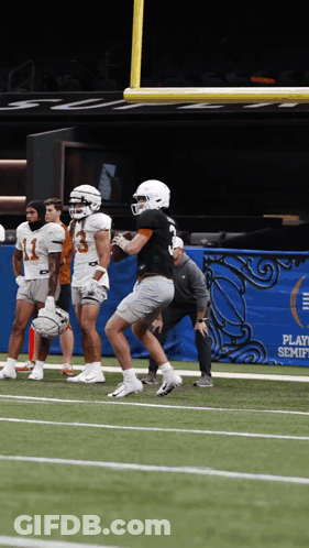 A Group Of Football Players Are On A Field In Front Of A Banner That Says Play Semifinals GIF