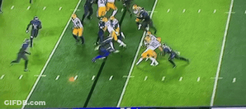 A Group Of Football Players Are On A Field . GIF