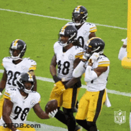 A Group Of Football Players Are On A Field With One Wearing A Number 98 Jersey GIF