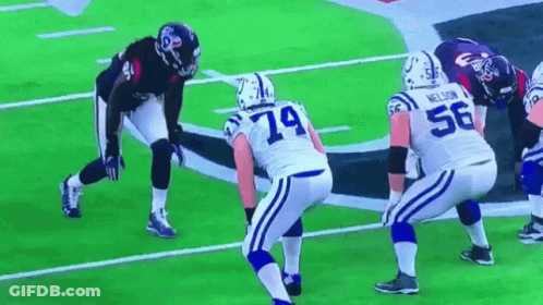 A Group Of Football Players Are On A Field With One Wearing The Number 56 GIF