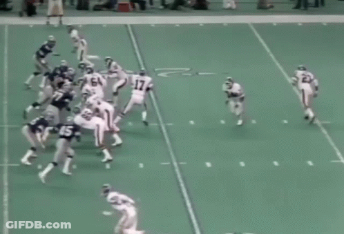 A Group Of Football Players Are Playing A Game On A Field And One Of Them Has The Number 60 On His Jersey GIF