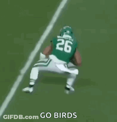 A Group Of Football Players Are Playing A Game On A Field And One Of Them Is Wearing A Number 23 Jersey . GIF