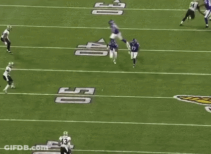 A Group Of Football Players Are Playing On A Field . One Of The Players Has The Number 14 On His Jersey . GIF