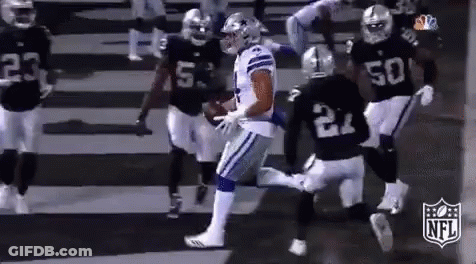 A Group Of Football Players Are Running On A Field . One Of The Players Has The Number 21 On His Jersey . GIF