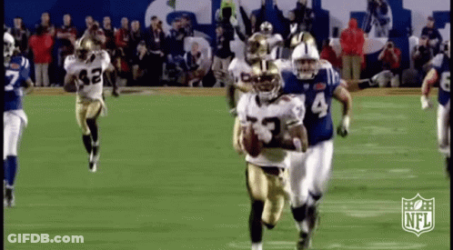 A Group Of Football Players Are Running On A Field With A Nfl Logo In The Background . GIF