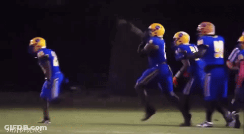 A Group Of Football Players Are Running On A Field With The Words Shot By Blake Visible In The Corner GIF