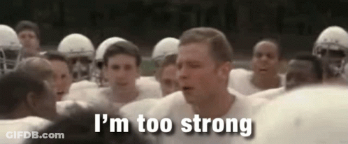 A Group Of Football Players Are Standing In A Huddle And A Man Is Standing In The Middle Of The Group . GIF