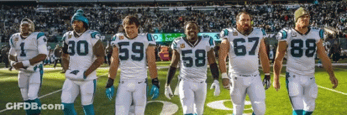 A Group Of Football Players Are Standing On A Field And One Has The Number 67 On His Jersey GIF