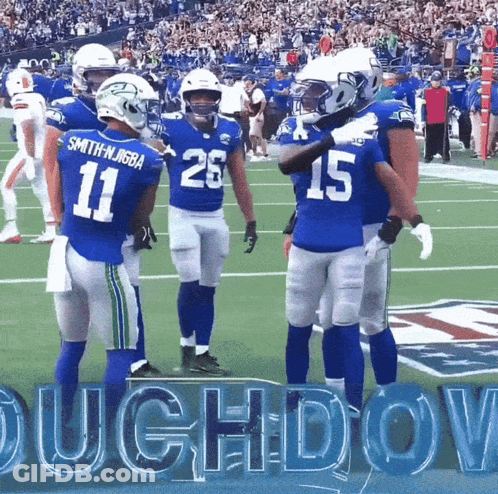 A Group Of Football Players Are Standing On A Field And One Of Them Has The Number 15 On His Jersey GIF
