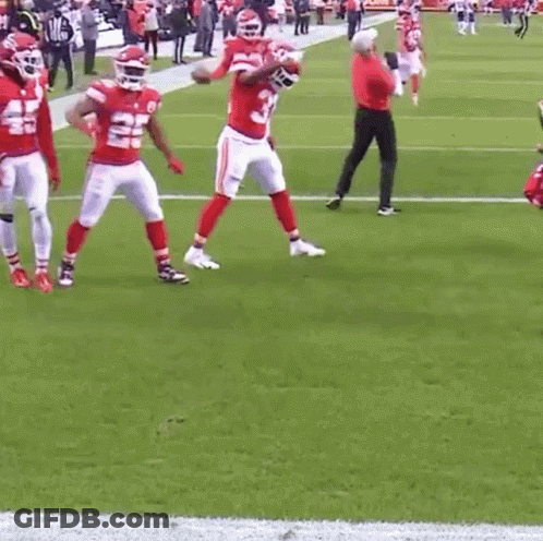 A Group Of Football Players Are Standing On A Field And One Of Them Has The Number 22 On His Jersey GIF