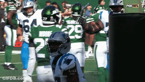 A Group Of Football Players Are Standing On A Field And One Of Them Has The Number 29 On His Jersey GIF