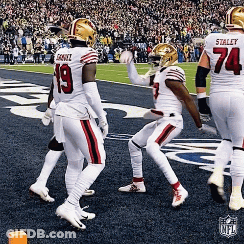 A Group Of Football Players Are Walking On The Field And One Of Them Has The Number 19 On His Jersey GIF