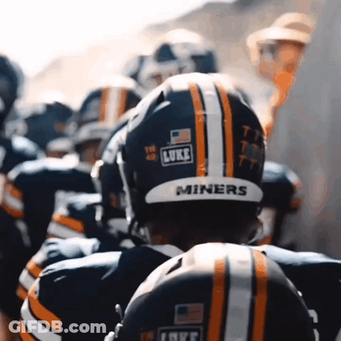 A Group Of Football Players Are Wearing Helmets That Say Miners GIF