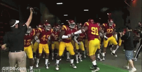 A Group Of Football Players In Red Uniforms With The Number 91 On The Back GIF
