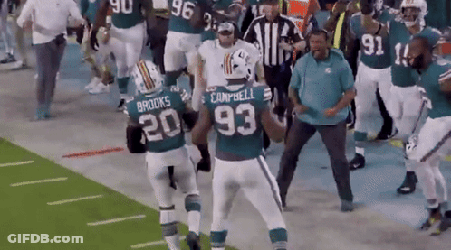 A Group Of Football Players Including Campbell And Brooks Are On A Field GIF