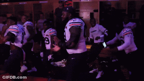 A Group Of Football Players Including Number 55 And Number 29 GIF