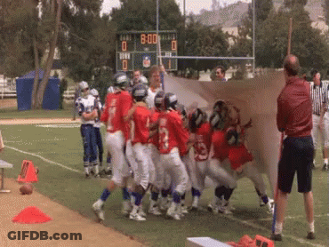 A Group Of Football Players On A Field With A Scoreboard In The Background That Says 80:00 GIF
