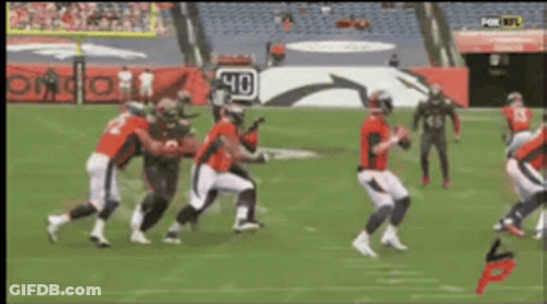A Group Of Football Players On A Field With A Sign That Says 40 On It GIF