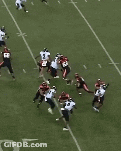 A Group Of Football Players On A Field With One Wearing The Number 68 GIF