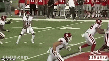 A Group Of Football Players On A Field With The Number 80 On The Back Of Their Jersey GIF