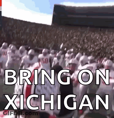 A Group Of Football Players Standing In A Stadium With The Words Bring On Michigan Written On The Screen GIF