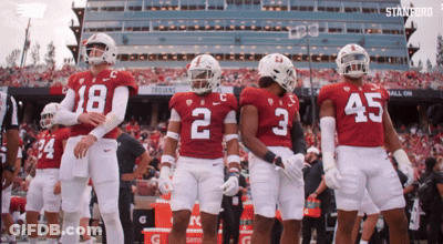 A Group Of Football Players Wearing Red And White Uniforms With The Number 2 On The Back GIF
